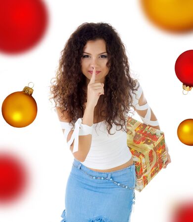 Cute woman  with the christmas gift. Studio isolated on a spheres backgroundの写真素材