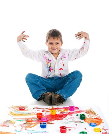 Adorable 3 year old boy covered in bright paint.の写真素材