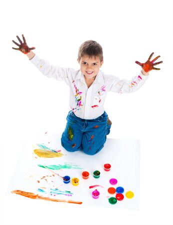 Adorable 3 year old boy covered in bright paint.の写真素材