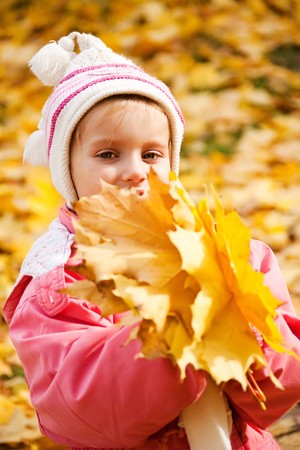 Autumn portrait of cute little caucasian girl の写真素材