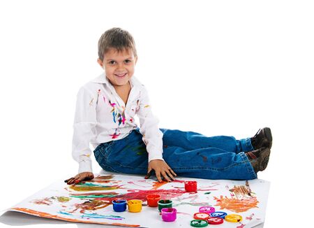 Adorable 3 year old boy covered in bright paint.の写真素材