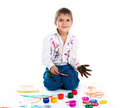 Adorable 3 year old boy covered in bright paint.の写真素材