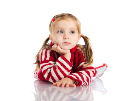 Cute girl lie on sweater and gumboots. Studio shotの写真素材