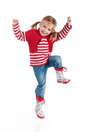 Little girl in autumn clothing jump  isolated on whiteの写真素材