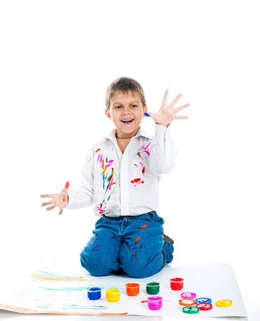 Adorable 3 year old boy covered in bright paint.の写真素材