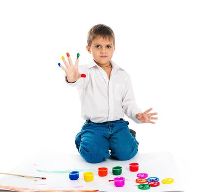 Adorable 3 year old boy covered in bright paint.の写真素材