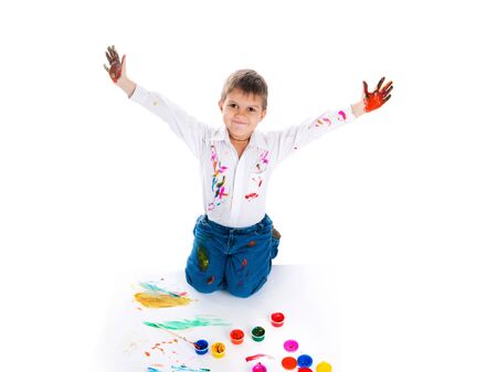 Adorable 3 year old boy covered in bright paint.の写真素材