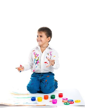 Adorable 3 year old boy covered in bright paint.の写真素材