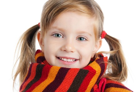 portrait of a cute little girl in a striped scarfの写真素材