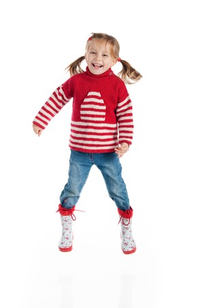 Little girl in autumn clothing jump  isolated on whiteの写真素材