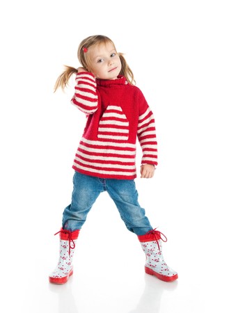 Little girl wearing sweater and gumboots isolated on whiteの写真素材