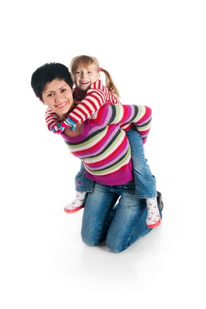 Smiling people. Mother and her daughter. Studio isolatedの写真素材