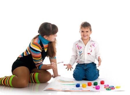 Adorable  boy and his mom covered in bright paint.の写真素材