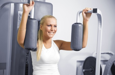 A young woman in a gym with a confident smileの写真素材