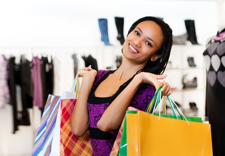 Beautiful  latin american women with packages shoppingの写真素材