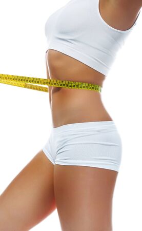Woman measuring perfect shape of beautiful waist. Healthy lifestyle concept の写真素材