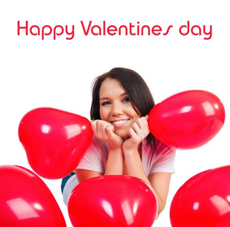Cute young girl with a red hearts over whiteの写真素材