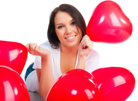 Cute young girl with a red hearts over whiteの写真素材