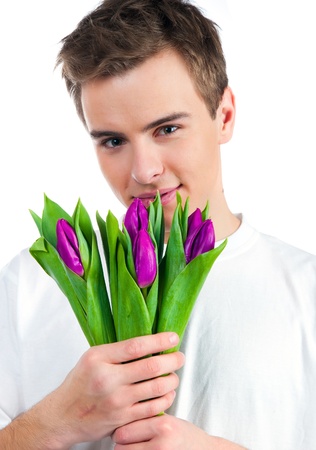 Cute young men give the flowers over white backgroundの写真素材