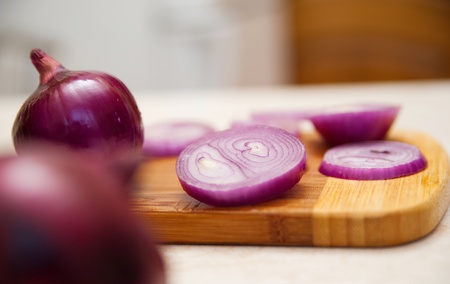 Close-up of fresh red onions on a wooden background の写真素材