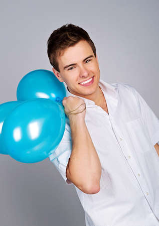 Cute young men with a ballons over whiteの写真素材