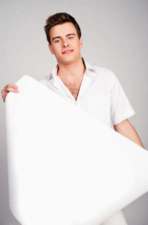 young man holding a paperの写真素材