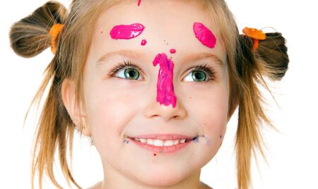 smiling girl with the palms painted by a paint.の写真素材