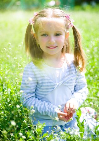 Cute little girl  on the meadowの写真素材