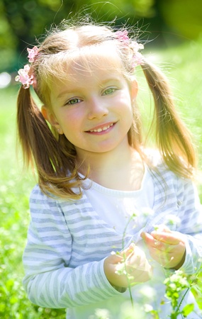 Cute little girl  on the meadowの写真素材