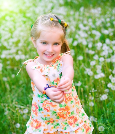 Cute little girl  on the meadowの写真素材