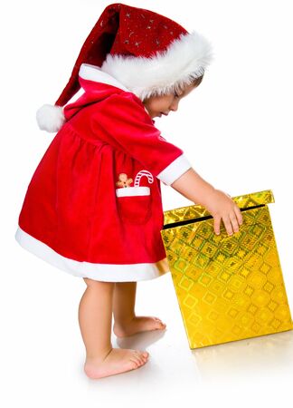 Little girl in santa hat with presentsの写真素材
