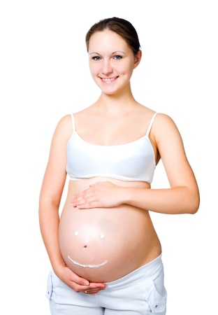 pregnant female with cosmetic cream on bellyの写真素材