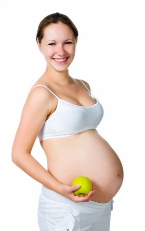 Beautiful pregnant  woman holding an appleの写真素材