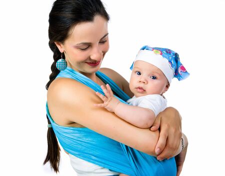 mother carrying her baby in a slingの写真素材