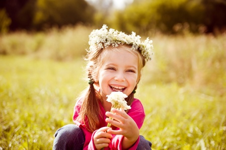 little girl in wreath of flowersの写真素材