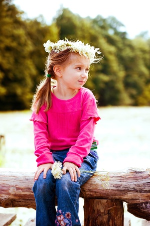 little girl in wreath of flowersの写真素材
