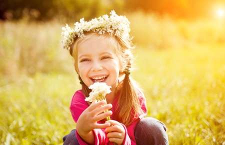 little girl in wreath of flowersの写真素材