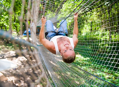 strong young men in a rope parkの写真素材