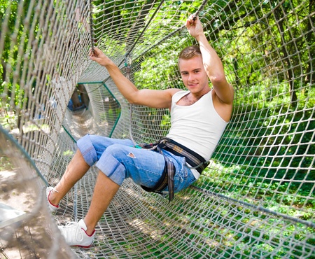 strong young men in a rope parkの写真素材