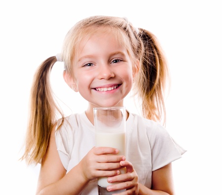 little girl holding a cup of milkの写真素材