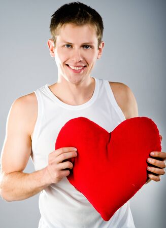 Cute young menl with a red heartの写真素材