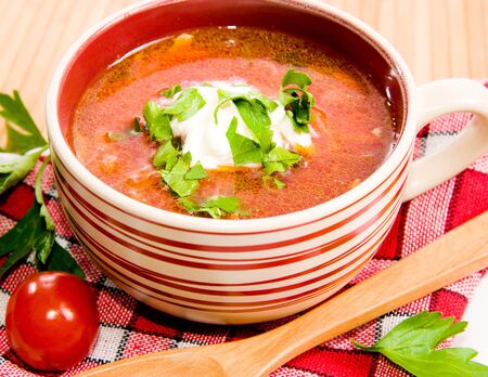 tomato soup with tomatoes in background ower white