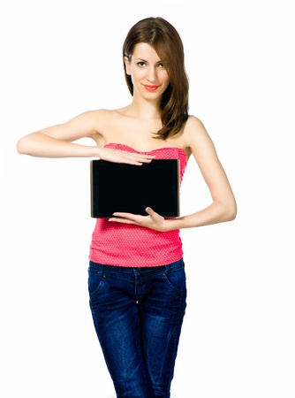 Portrait of young beautiful brunnete woman holding laptop  on whiteの写真素材