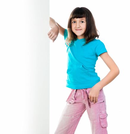 cute child behind a board over white backgroundの写真素材