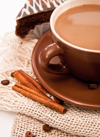 Ceramic cup of coffee with cinnamon on whiteの写真素材