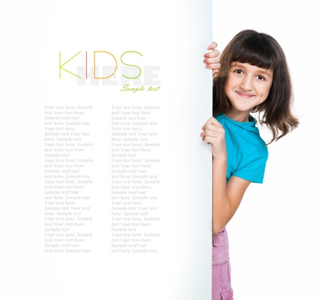 cute child behind a board over white backgroundの写真素材