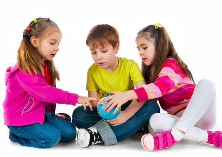 Kids with a globe of the world over white backgroundの写真素材