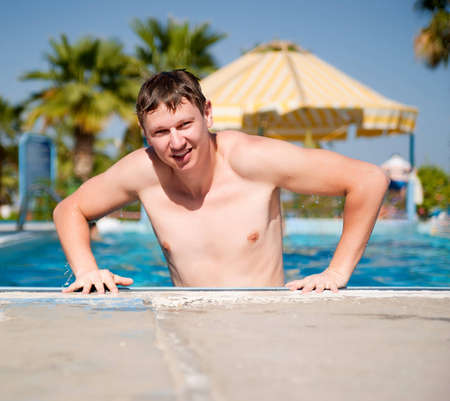 Attractive Young man in the pool blue background