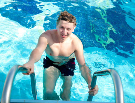 Attractive Young man in the pool blue background