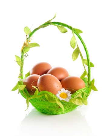 eggs on a green basket  white backgroundの写真素材